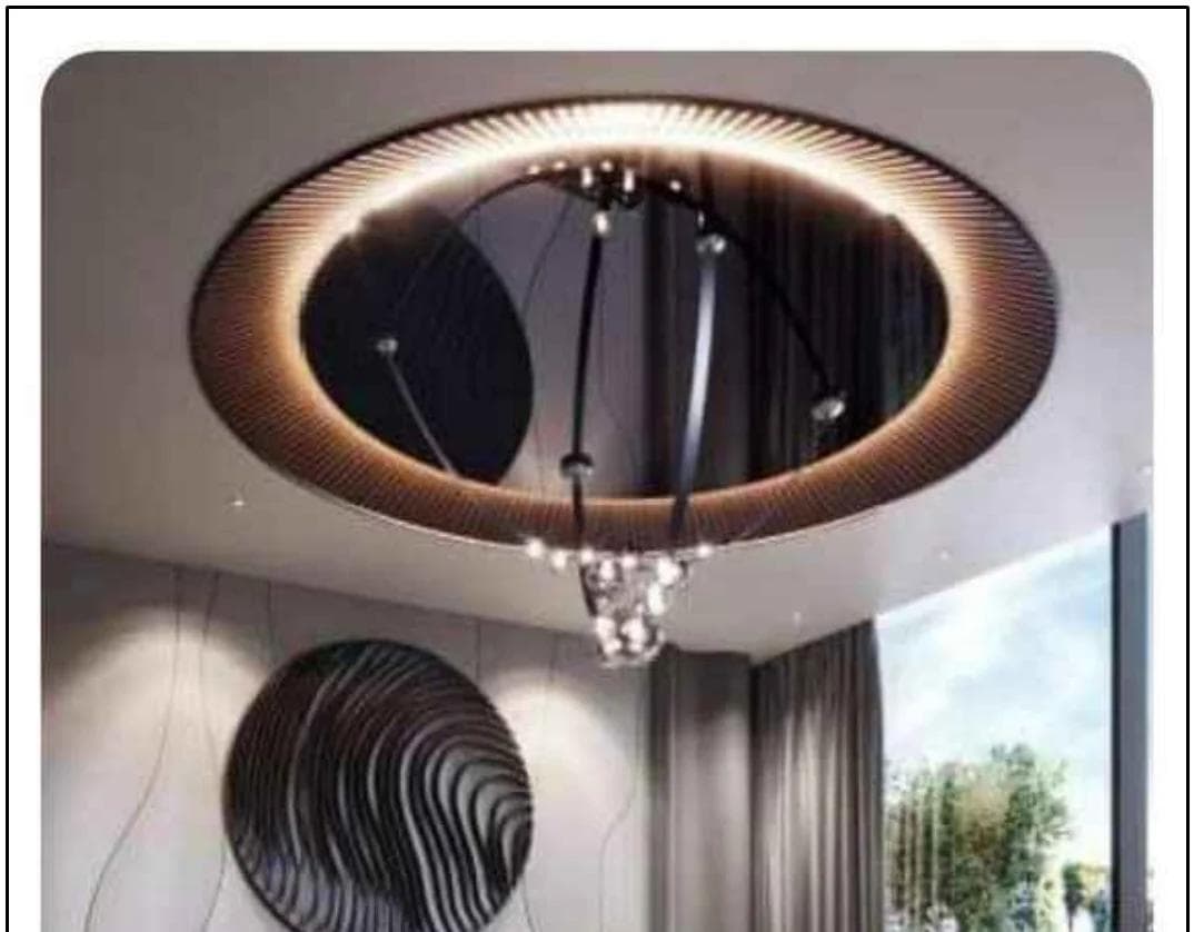 Circular cove-lit false ceiling above a dining setting in plum upholstery